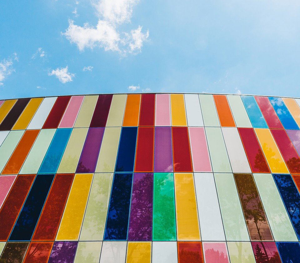 Looking up at a building covered in multi-colored panels